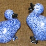A pair of speckled blue ceramic ducks